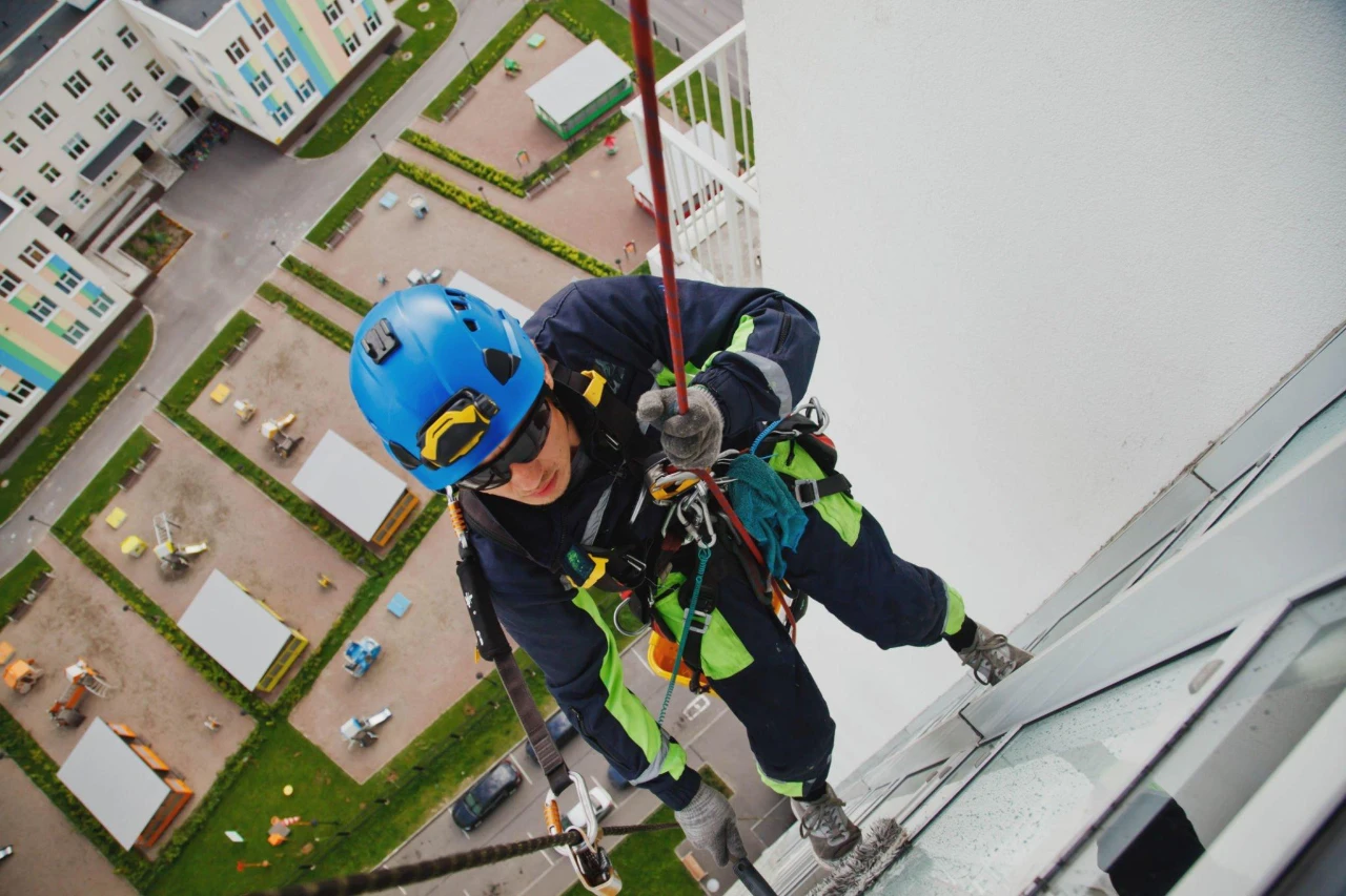 A man wearing safety gears and working at height